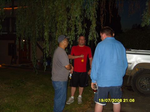 1989 Ford Bronco - A group of men converse outdoors in the evening, with a vehicle partially visible in the background.