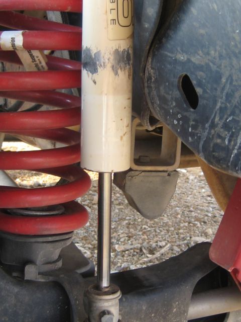 1996 Ford Bronco - Vehicle suspension components, including a shock absorber and red coil spring, are visible.
