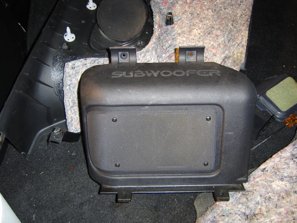 car's interior subwoofer housing with text on top