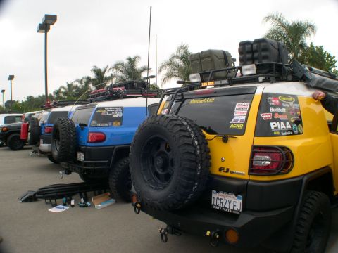 2007 Toyota FJ Cruiser - Multiple Toyota FJ Cruisers parked in a lot, some with aftermarket modifications.