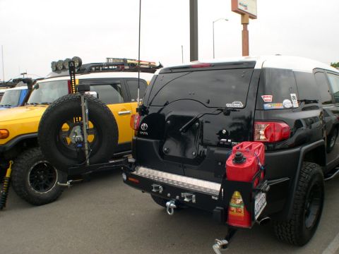 2007 Toyota FJ Cruiser - Two Toyota FJ Cruisers parked side-by-side, one black and one yellow, with aftermarket accessories visible.