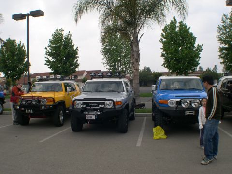 2007 Toyota FJ Cruiser - Three Toyota FJ Cruisers are parked in a lot, showing off their distinctive styling.