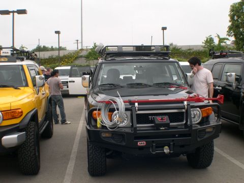 2007 Toyota FJ Cruiser - Two Toyota FJ Cruisers are parked together at an outdoor event.
