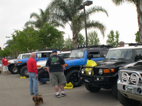 2007 Toyota FJ Cruiser - A group of Toyota FJ Cruisers are parked together outdoors with people milling about.