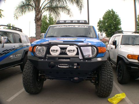 2007 Toyota FJ Cruiser - Two Toyota FJ Cruisers are parked side-by-side at an outdoor event.