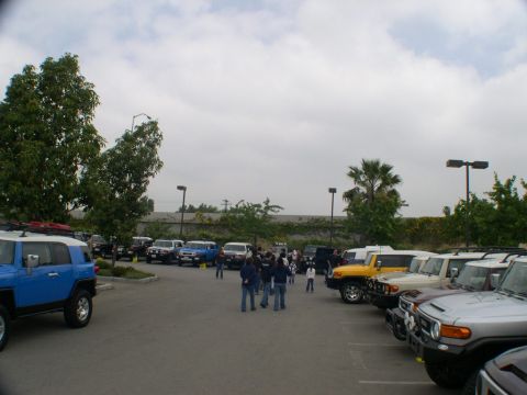 2007 Toyota FJ Cruiser - A gathering of Toyota FJ Cruisers in a parking lot under a cloudy sky.