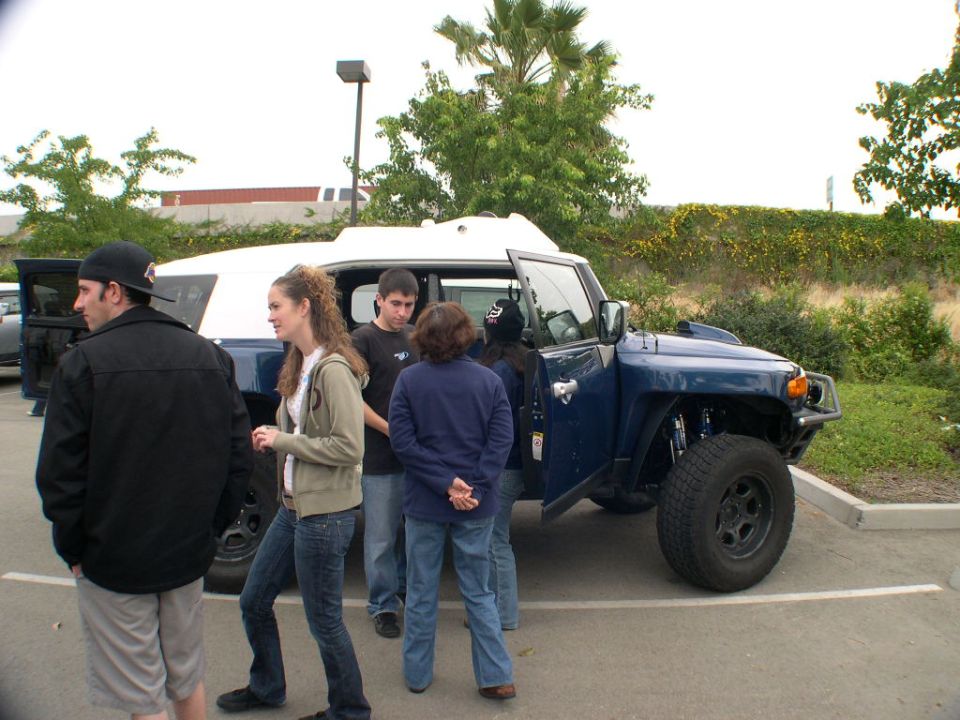 Blue 2007 Toyota FJ Cruiser with white roof, front passenger door open, parked in a lot