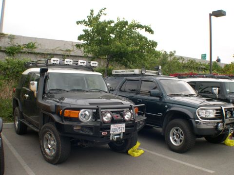 2007 Toyota FJ Cruiser - Two off-road SUVs, a Toyota FJ Cruiser and a Toyota 4Runner, are parked side-by-side.