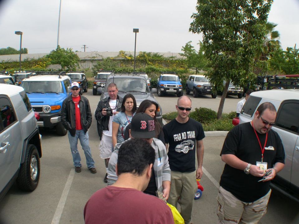Group of people standing in front of multiple Toyota FJ Cruisers.