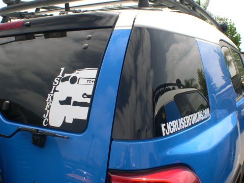 2007 Toyota FJ Cruiser - A blue Toyota FJ Cruiser is seen from the rear with forum and vehicle stickers on the window.