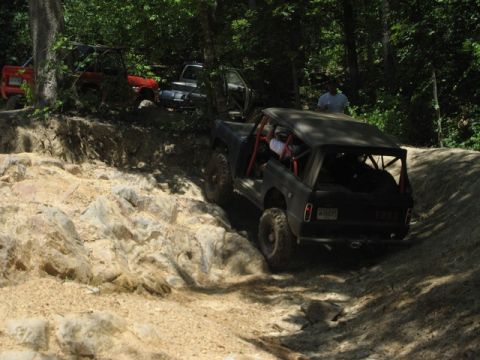 1995 Ford Bronco - Multiple off-road vehicles navigate a challenging rocky terrain.