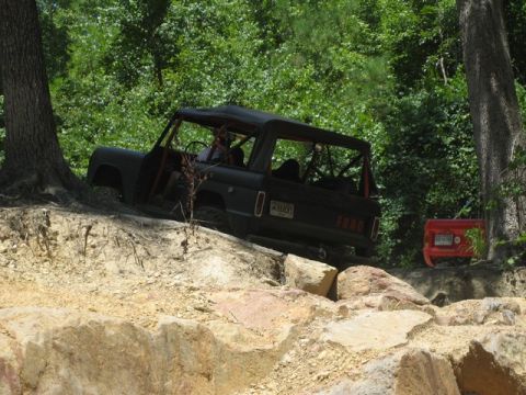 1995 Ford Bronco - Ford Bronco navigating a challenging rocky off-road course with another vehicle nearby.