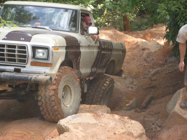 Tan and brown Ford F-Series truck on rocky off-road trail