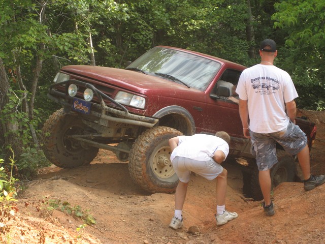 Red SUV with brush guard and off-road tires, 1995 model year visible on badge