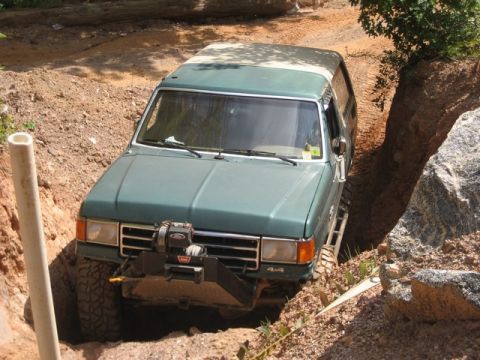 1995 Ford Bronco - This SUV is navigating a challenging off-road obstacle course.