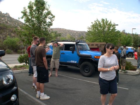 2007 Toyota FJ Cruiser - A blue Toyota FJ Cruiser is parked in a lot, with several people standing nearby. Another FJ Cruiser is visible in the background.