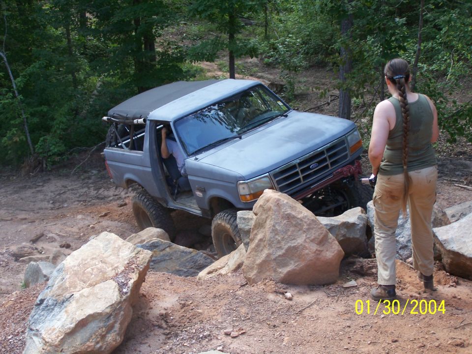 Gray off-road truck with canvas top on rocky terrain