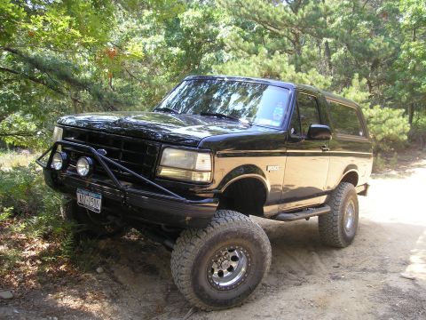 1995 Ford Bronco - This black Ford Bronco, likely from the early to mid-1990s, is equipped for off-road use.