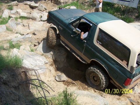 1979 Ford F-150 - Ford Bronco tackling an off-road obstacle course on a sunny day.