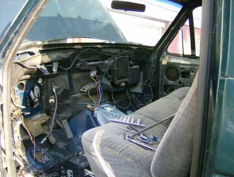 1990 Ford Bronco - Dash taken out of the bronco to be rewired. Bench seat from the donor truck installed to replace the worn out half back bucket seats.