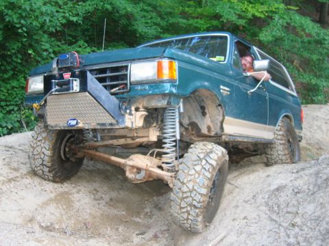 1992 Ford Mustang - This modified Ford Bronco is navigating a challenging off-road trail.