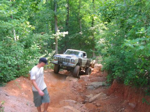 1992 Ford Mustang - Ford F-Series pickup truck navigates a challenging rocky off-road trail.