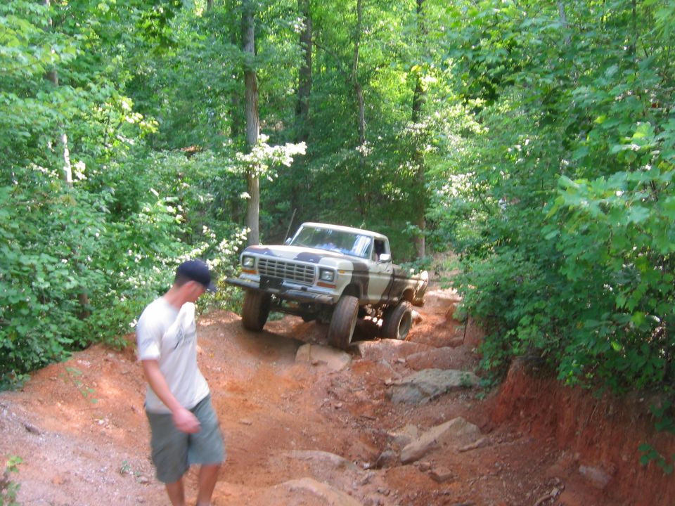 1979 Ford F-Series pickup truck with camouflage paint on a rocky trail