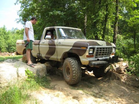 1979 Ford F-150 - This 1979 Ford F-150 is navigating a challenging off-road course with its distinctive camouflage paint scheme.