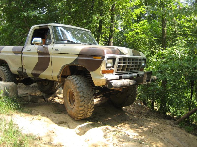 1979 Ford F-150 pickup truck with camouflage paint on a dirt trail