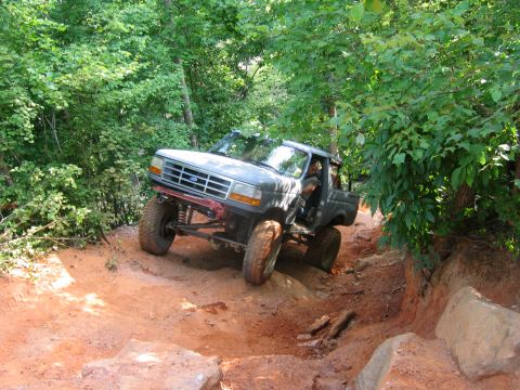 1992 Ford Mustang - Ford Bronco navigating a challenging off-road trail.