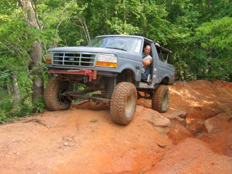 1992 Ford Mustang - A gray 1992 Ford Bronco navigates a rocky, off-road trail.