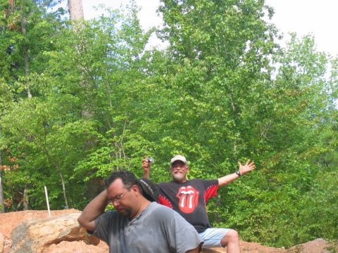 1992 Ford Mustang - Two men pose for a photo outdoors amidst trees and rocks.