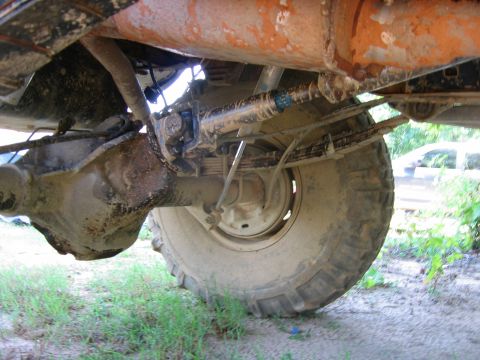 1992 Ford Mustang - Undercarriage view of a vehicle's rear axle and suspension system, showing wear and dirt.