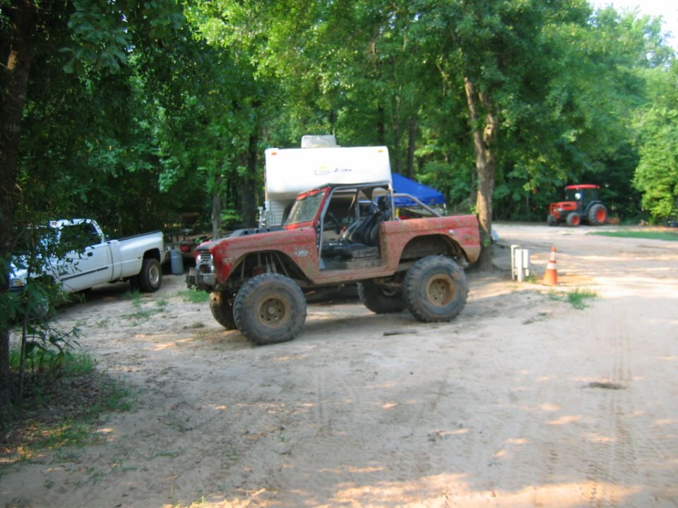 Red off-road SUV with large tires and no doors