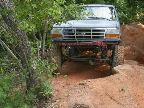 1990 Ford Bronco - This 1990 Ford Bronco navigates a challenging off-road course with large tires and a lifted suspension.