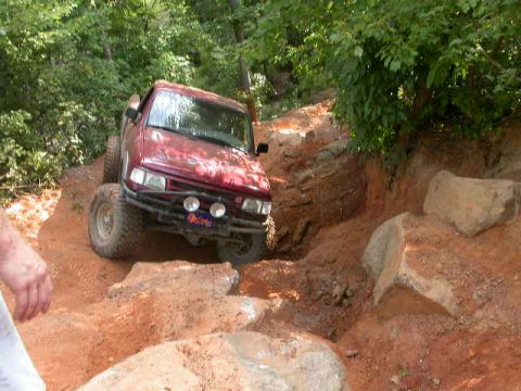 1990 Ford Bronco - This 1990 Ford Bronco tackles a challenging off-road course with steep inclines and large rocks.