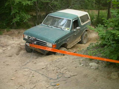 1990 Ford Bronco - This 1990 Ford Bronco appears to be stuck in the mud, with a winch attached to its front bumper.