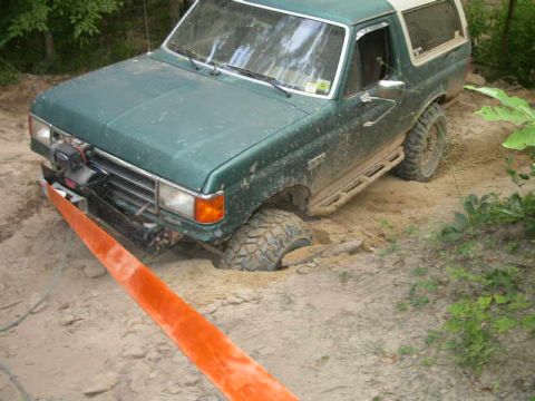 1990 Ford Bronco - This 1990 Ford Bronco is stuck in the sand, requiring a tow strap for extraction.