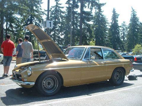 2000 Ford Crown Victoria - Gold coupe with hood open, parked outdoors with trees in background. Number 11 sign visible.