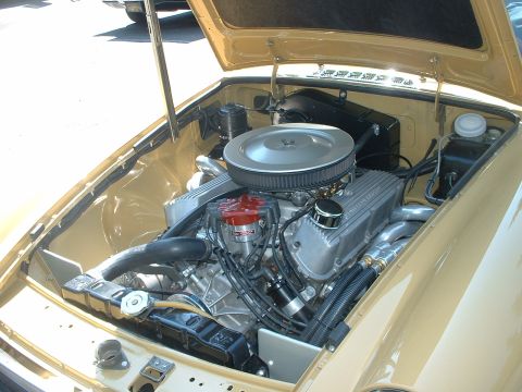 2000 Ford Crown Victoria - The engine compartment of a classic car is shown with its hood open, revealing a powerful V8 engine and various components.