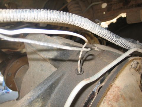 1995 Ford Bronco - Close-up view of a differential housing on a 1995 Ford Bronco. Two white wires are visible entering a small opening on the housing, with a…
