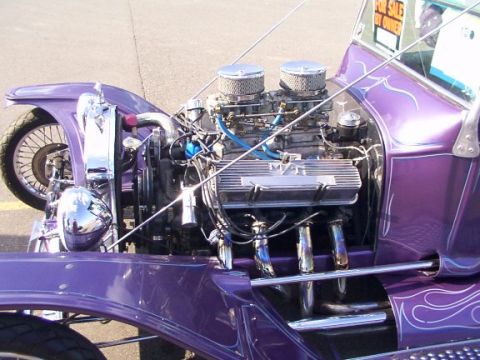 1998 Ford Taurus - A custom hot rod displays its powerful V8 engine with chrome accents and flame decals.