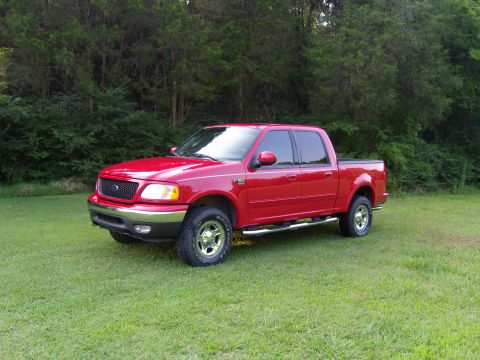 2007 Ford Mustang - Photograph of a red Ford pickup truck in a field, not a technical document.