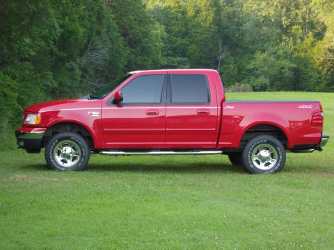 2007 Ford Mustang - Photograph of a red Ford F-150 crew-cab pickup shown in side profile on grass.