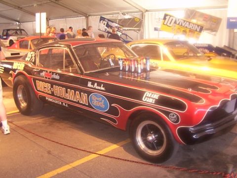 1998 Ford Taurus - A drag racing car with custom paint and modifications is displayed indoors.