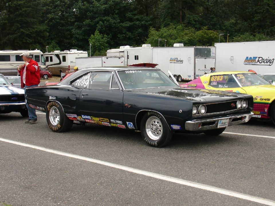 Dark green 1960s Dodge Coronet R/T drag car on Hoosier slicks in the pits