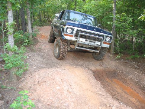 1978 Ford Bronco - This 1978 Ford Bronco is navigating a challenging off-road course through a wooded area.