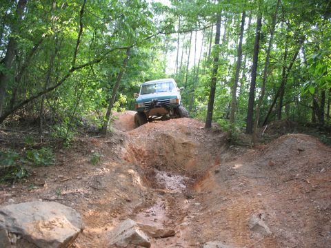 1978 Ford Bronco - Off-roading in a modified SUV on a challenging dirt trail through the woods.
