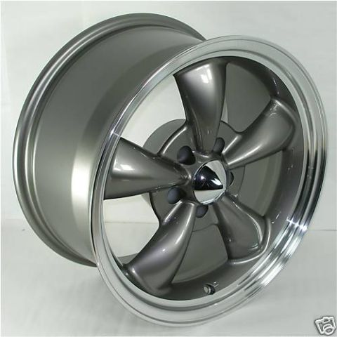 1983 Ford Bronco - A single gray five-spoke wheel with a chrome center cap is shown against a white background.