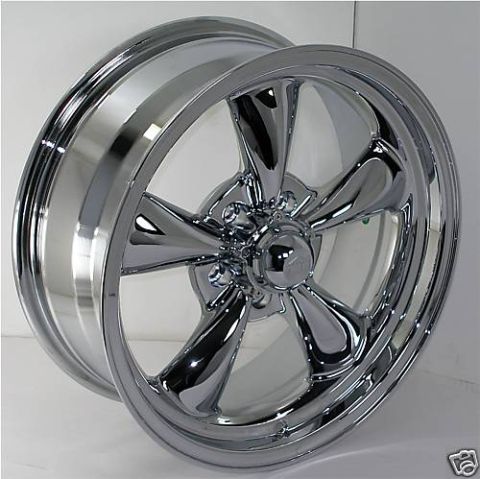 1983 Ford Bronco - Aftermarket chrome wheel with five spokes, shown against a white background.